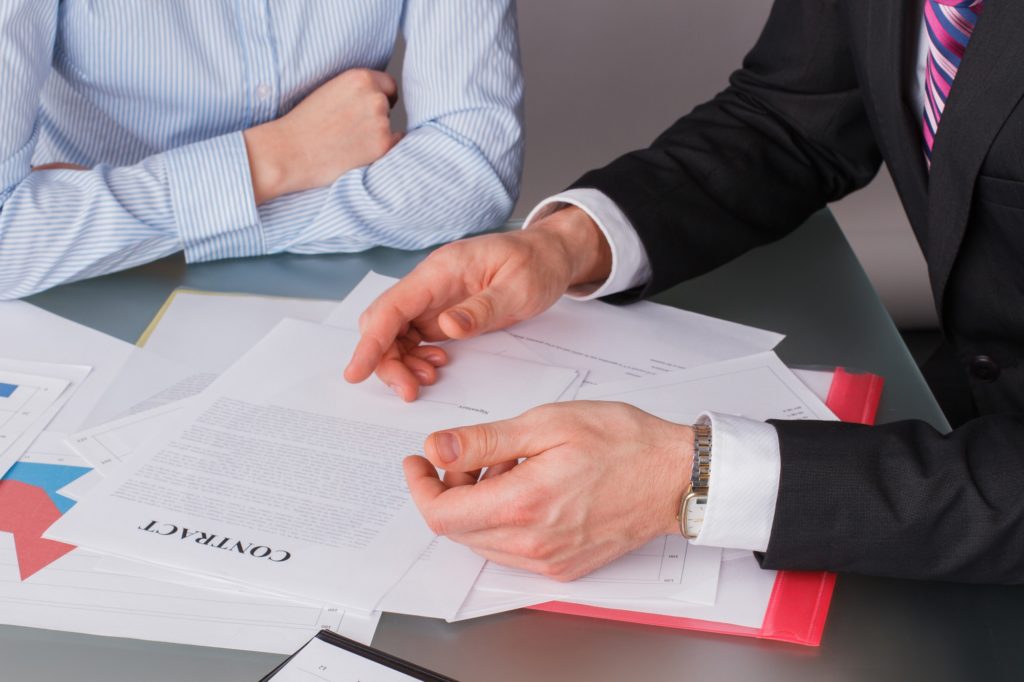 Businessman and business woman at business meeting.